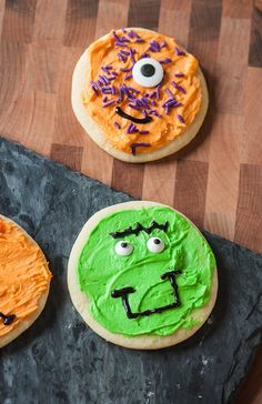 three decorated cookies with faces on them