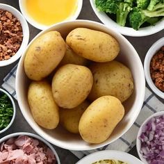 several bowls filled with different types of food including potatoes, broccoli and other ingredients