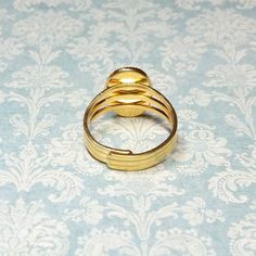 "The focal of this pretty ring is a 14x10mm rose decal cameo. The porcelain cameo is set in a gold plated brass adjustable ring. This ring is adjustable to approximately sizes 7 to 8. 🌹 If you would like me to presize this ring for you, just add a note to your order at checkout or convo me. 🌺 Please Note: It is not recommended to get costume jewelry rings wet for extended periods of time. 🌸 Please Note: All of my rings are coated on the inside with \"Jewelry Shield\". If you have concerns abo Adjustable Vintage Rose Gold Rings, Vintage Adjustable Rose Gold Ring, Adjustable Gold Flower Ring For Formal Occasions, Adjustable Vintage Gold Signet Ring, Adjustable Gold Cameo Jewelry, Vintage Adjustable Gold Signet Ring, Adjustable Gold Rings With Cabochon, Adjustable Vintage Gold Flower Ring, Vintage Adjustable Gold Flower Ring