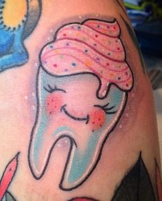 a cartoon tooth with sprinkles and a cupcake on it's head