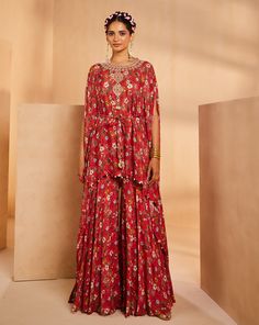 Featuring a floral-printed kaftan and sharara. The kaftan’s neckline is embroidered by hand using a mirror, sequences, and beadwork. The tie-up is accentuated with mirrors and the kaftan hem is accentuated with antique gold coins.From Aneesh Agarwaal's Seher collection.DELIVERY TIMEPlease allow 8-12 weeks for your outfit to arrive.FABRIC DETAILSChinonProfessional cleaning only. Bohemian Red Sharara With Mirror Work, Red Bohemian Sharara With Mirror Work, Red Maxi Length Set With Mirror Work, Red Bohemian Floor-length Sharara, Festive Floral Print Tunic Set, Traditional Embellished Red Kaftan, Red Bohemian Floor-length Set, Red Embroidered Bollywood Kaftan, Red Printed Silk Kaftan