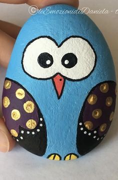 a painted rock with an owl on it