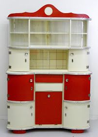 an old fashioned red and white cabinet with glass doors on the top, bottom shelf