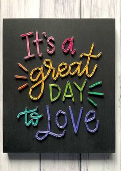 it's a great day to love written in crayons on a black board