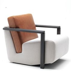 a white and brown chair sitting on top of a white floor next to a black metal frame