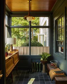 the sun shines in through an open window into a room with blue tile flooring