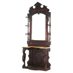 an ornate wooden vanity with mirror and stool