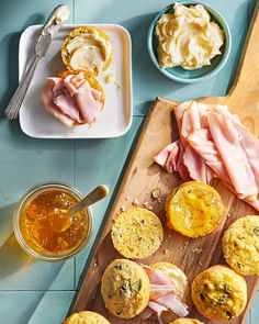 ham and cheese muffins on a wooden cutting board with honey syrup in bowls