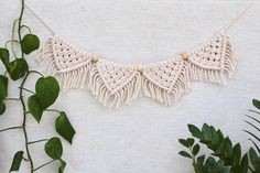 a white crocheted necklace with wooden beads and tassels on a string