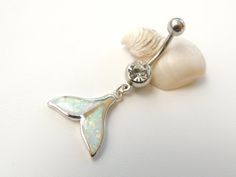 an opalite and white shell pendant on a silver plated chain with a crystal bead