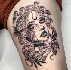 a woman's face with flowers and leaves on her thigh, as if it were tattoo art