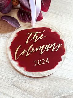 a glass ornament with the words the coffman's on it