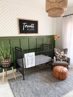 a baby crib in a room with green walls and rugs on the floor