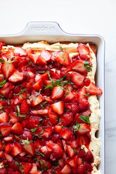 strawberry shortbread with cream cheese and fresh mint sprinkled on top, ready to be eaten