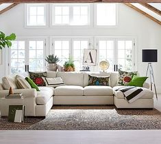 a living room filled with furniture and lots of windows