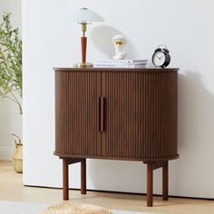 This accent storage cabinet draws inspiration from the refined simplicity of the modern style, with a flowing oval silhouette accented by textural ribbed detailing. Sliding two door cabinet is can to match naturally within many existing interior styles. The entire storage cabinet is made of sturdy MDF, mounted on slender solid wood legs. The sliding tambour doors open all the way so you can access and make full use of the storage space. Sign nature slatted paneling on the main body of this piece Small Home Bar Ideas, Credenza Storage, Bar Buffet Cabinet, Small Bars For Home, Slide Doors, Dining Room Cabinet, Entryway Cabinet, Accent Storage Cabinet