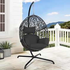 an outdoor swing chair on a porch