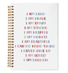 a spiral notebook with the words i am kind and i am brave written on it