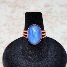 Light Sapphire Blue Star Ring, Vintage Glass Cabochon Ring, Copper Ring, Blue Ring, Costume Jewelry Ring, Adjustable Ring Size 6-8 Adjustable Blue Cabochon Moonstone Ring, Adjustable Blue Moonstone Cabochon Ring, Adjustable Blue Moonstone Ring With Cabochon, Costume Jewelry Rings, Light Sapphire, Blue Ring, Copper Ring, Cabochon Ring, Ring Blue