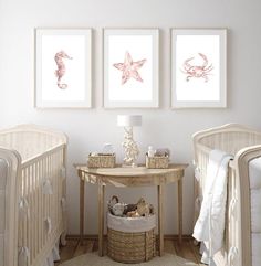 three framed pictures hang on the wall above a crib in a baby's room