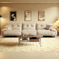 a living room filled with white furniture and lots of lights on the wall above it