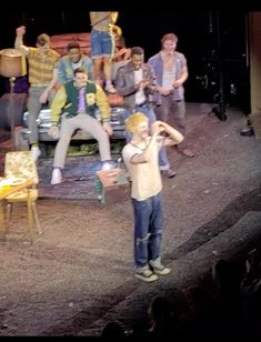 a group of young men standing on top of a stage