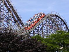 a roller coaster with many people riding it