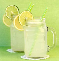 two mason jars filled with lemonade and drinking straws