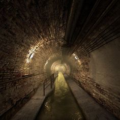 an underground tunnel with water running through it