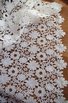 white lace is laying on top of a wooden table