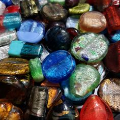 many different colored glass beads together