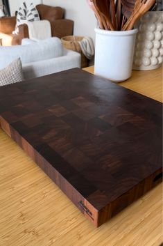 a wooden cutting board sitting on top of a table