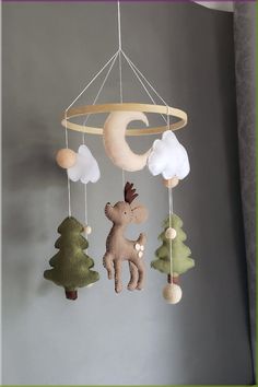 a crib mobile with a moose and moon hanging from it