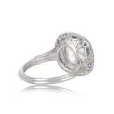 This stunning diamond and sapphire ring features a bold 3.67 carat old mine cut diamond with J color and VS1 clarity. Set in handcrafted platinum, stunning filigree adorns the under gallery, with accenting diamonds along the shoulders, a halo of sapphires surrounds the center gem. ✦ DIAMOND SPECIFICATIONS: Diamond Clarity: VS1 Diamond Color: J Color Diamond Weight 3.67 Carats ✦ ENGAGEMENT RING SPECIFICATIONS: Ring Material: Platinum Stones: Diamond, Sapphire ✦ WHAT COMES IN YOUR SHIPMENT: - Your Platinum Halo Ring With Single Cut Diamonds, Luxury Sapphire Ring With Diamond White Round Cut, Luxury Sapphire Ring In Diamond White, Luxury Diamond White Sapphire Ring With Round Cut, Luxury White Gold Topaz Ring With Halo Setting, Luxury Platinum Topaz Ring With Prong Setting, Luxury Diamond White Sapphire Round Ring, Luxury Platinum Topaz Ring With Halo Setting, Luxury Diamond White Sapphire Ring