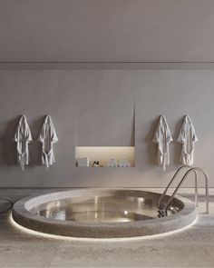 an indoor jacuzzi tub with towels hanging on the wall