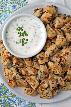 a white plate topped with chicken and ranch dressing