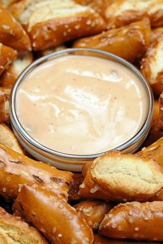 a plate full of pretzels with a dip in the middle