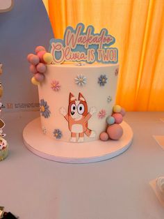 there is a cake that has been decorated with flowers and an image of a fox on it