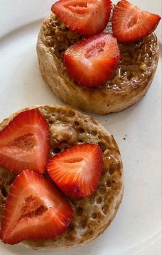 two pastries topped with strawberries on a white plate