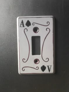 a white light switch cover with playing cards on it