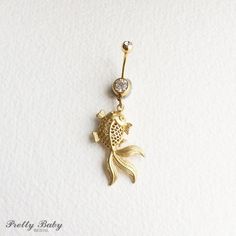 beach wedding belly ring, goldfish belly ring, fish, gold belly ring, Belly button ring,goldfish jewelry, bellybutton ring, MATTE GOLDFISHPLEASE SEE SHIPPING TAB FOR TURNAROUND TIMEPretty belly ring in surgical steel colored GOLDwith a CLEAR gemand a 3D matte gold plates goldfish - this charm is about 1/4 "thick entire piece approx 2 1/4" long. /5.5 cm14 gaugeLarge barbell rhinestone approx 7mm acrossTo keep the rhinestones looking their best I recommend you do not wear this piece while swimming Adjustable Gold Belly Rings For Wedding, Goldfish Jewelry, Bellybutton Ring, Belly Button Piercing Jewelry, Gold Plates, Gold Belly Ring, Button Piercing, Feather Fascinators, Belly Piercing