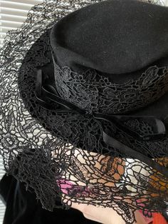 1930's/40's black dramatic hat with a HUGE brim made of stiff lace. Tag by Millenary Hilpatricks Black Gatsby Style Hats For Evening, Elegant Black Hat For Costume, Elegant Black Costume Hat, Vintage Brimmed Top Hat For Party, Elegant Black Top Hat For Costume, Elegant Black Costume Top Hat, Vintage Black Costume Hat With Curved Brim, Vintage Black Brimmed Hat, Vintage High Crown Black Costume Hat