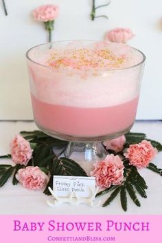 baby shower punch in a glass bowl with pink flowers around it and the words, baby shower punch