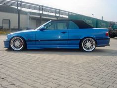 a blue car parked in front of a building