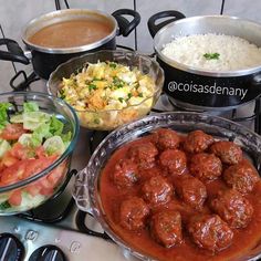 a table topped with lots of different types of food next to pots and pans