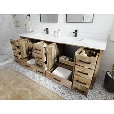 a bathroom vanity with two sinks and wooden drawers in front of a tiled shower area