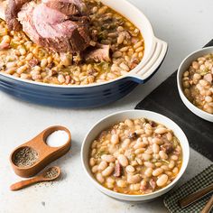 three bowls filled with beans and meat on top of a table