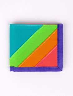 This rad wallet is the perfect place to keep all of your money related objects! Features 6 front-facing credit card slots with 2 extra hidden slots, a main cash pocket, color block detailing, and nylon binding. Shop all WalletsShop all Dragonfly Measures 9" wide x 4" tall unfolded, 4.5" wide folded.Water resistant 100% Coated Nylon Made in Los Angeles, California Multicolor Bifold Wallet For Everyday Use, Cheap Multicolor Trifold Wallet With Card Slots, Modern Multicolor Wallets For Everyday Use, Multicolor Rectangular Trifold Wallet For Daily Use, Everyday Multicolor Bifold Wallet, Multicolor Bifold Wallet For Travel, Multicolor Bifold Wallets For Travel, Multicolor Bifold Wallet With Interior Card Slots, Multicolor Bifold Wallets With Card Slots