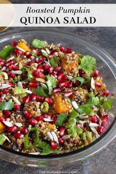 roasted pumpkin quinoa salad with pomegranate and herbs in a glass bowl