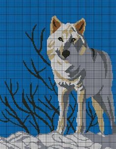 a cross - stitch pattern of a wolf standing on top of a snow covered hill